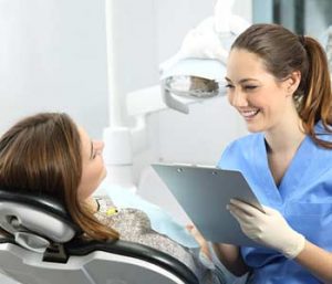 Dentist recording patient's histoy